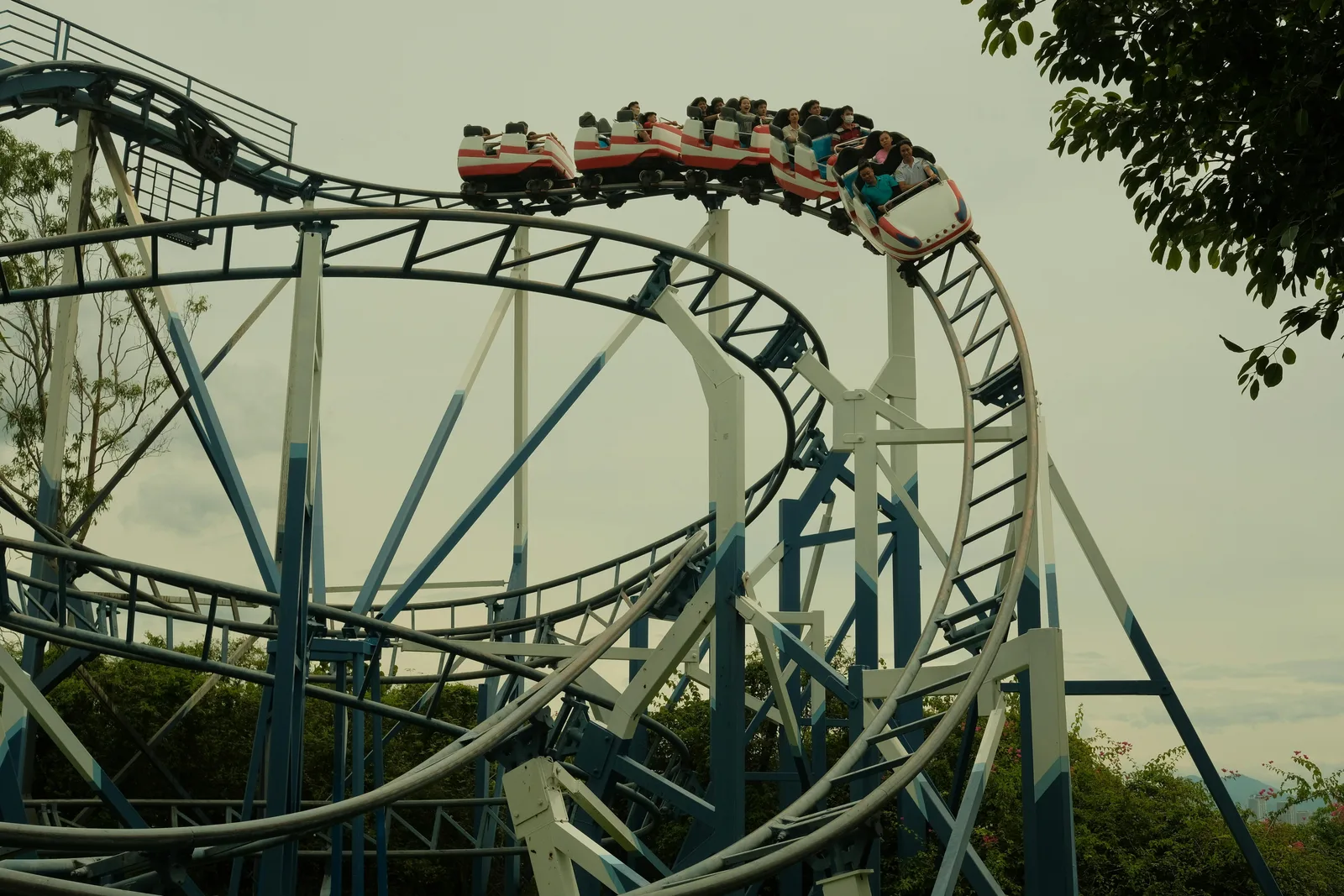 Cost of Equity Explained: How CAPM and Beta Actually Work A roller coaster on its track — a visual metaphor for beta and stock volatility, where a high-beta stock amplifies the market swings and raises the cost of equity