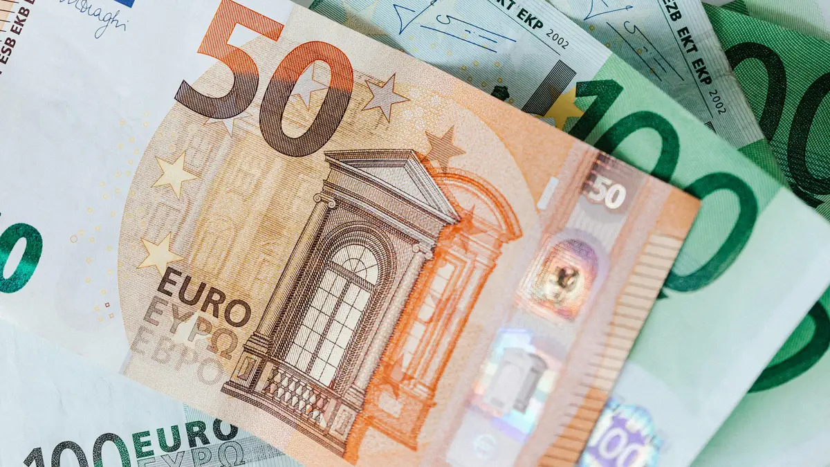 How Currency Risk Affects Your Investment Returns Assorted banknotes from different countries representing assets held across multiple currencies