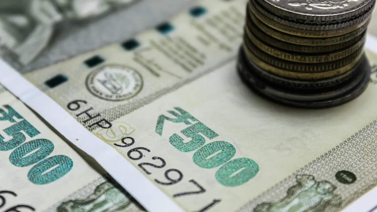 A balance scale weighing one currency against another, the margin of safety on a foreign holding must survive an adverse exchange-rate move