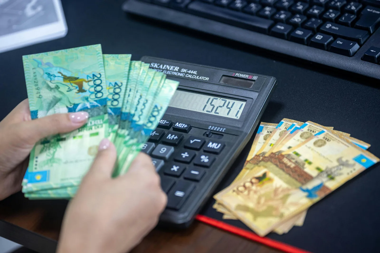 A calculator and banknotes on a desk — working through the WACC formula by hand to compute the weighted average cost of capital step by step